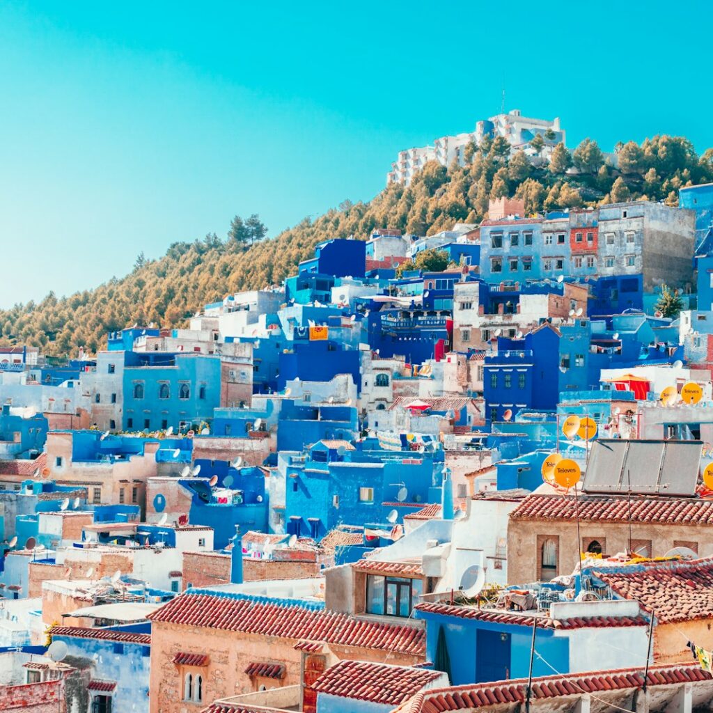 blue and white painted houses on the cliff