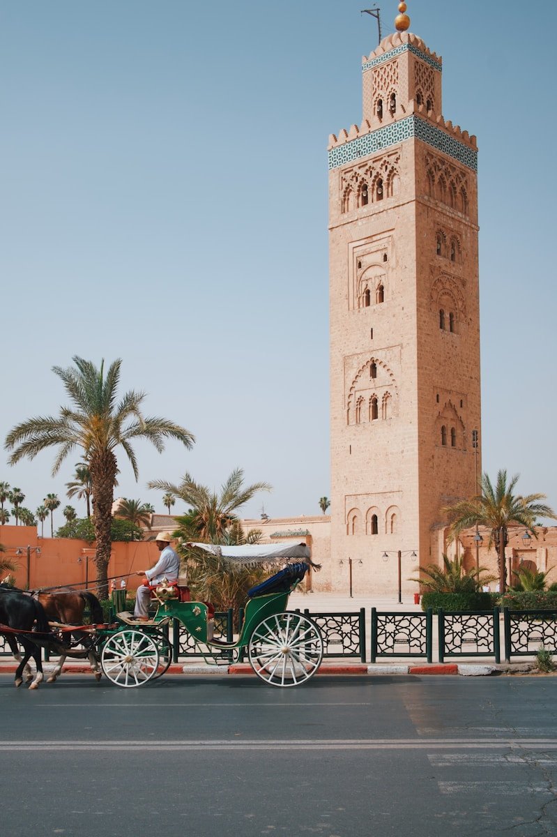Koutoubia Mosque and traditional horse carriage in Marrakech Morocco