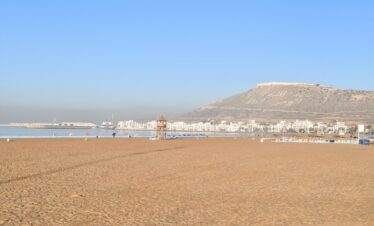 a beach with a mountain in the background