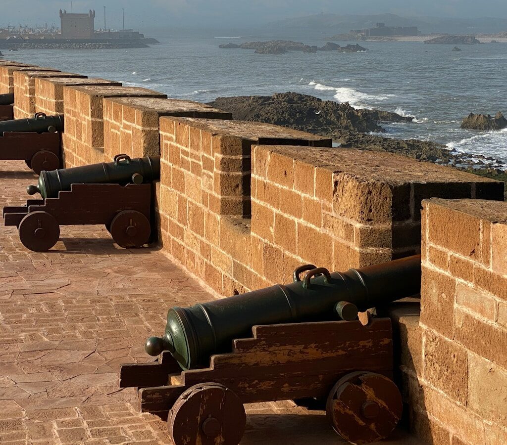a brick wall with cannons on it