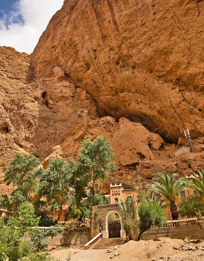 A large rock formation with a building in the middle of it